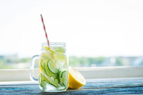 stock-photo-jug-with-lemon-and-cucumber-infused-water-on-a-rustic-wooden-table-429985366